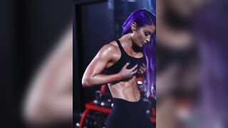 Eva Marie holding up her large breasts.