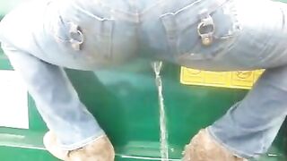 Wetting her jeans while climbing on a dumpster