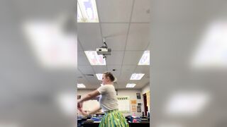 Busty teacher dancing in classroom.
